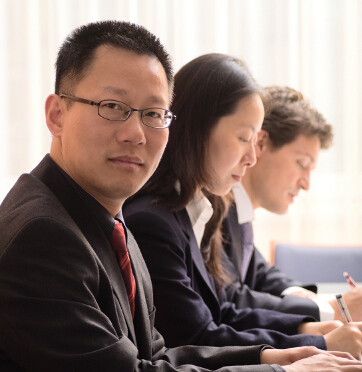 a young chinese businessperson sitting a a table